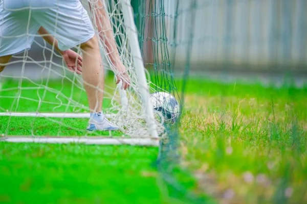 soccer player scoring goal